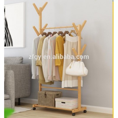 Freestanding wooden clothing store display rack with wheels